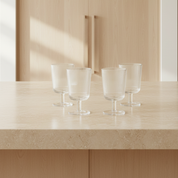 Pilastro Wine Glass Set by Stelton with four clear ribbed wine glasses featuring an Art Deco-inspired design and footed base.