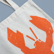 Lobster Catch Tote Bag by Kautzi Illustrations with a bright orange lobster screen-printed on natural cotton.