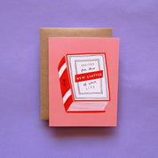Badger & Burke New Chapter Card featuring an illustrated red and white striped book on a pink background with text reading “Excited for this new chapter of your life.”