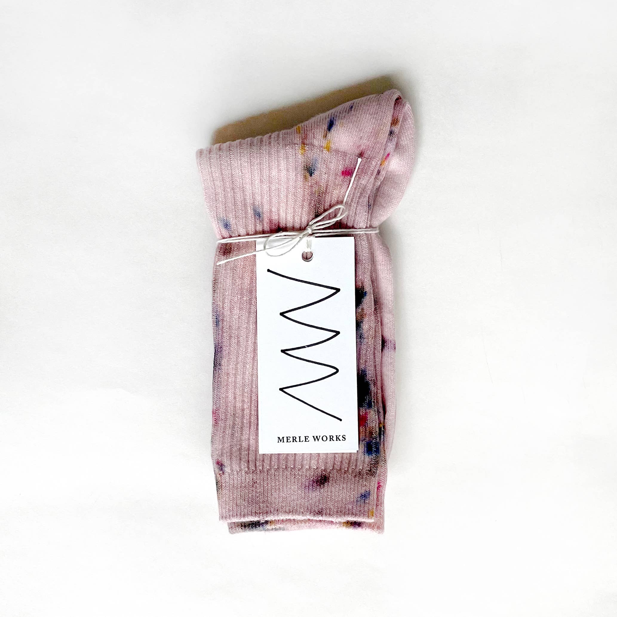 Maplewood Hand-Dyed Dressy Socks by Merle Works in soft blush pink with colorful hand-dyed speckles, ribbed cotton texture, and a lightweight crew-length design.