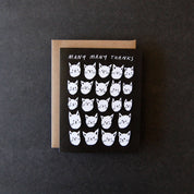 Badger & Burke Many Many Thanks Card featuring rows of white cat faces on a black background with “Many Many Thanks” text at the top.