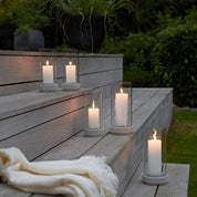 Stelton Hurricane Candle Holders in sand stoneware with glass shade, weather-resistant for indoor or outdoor candlelight.