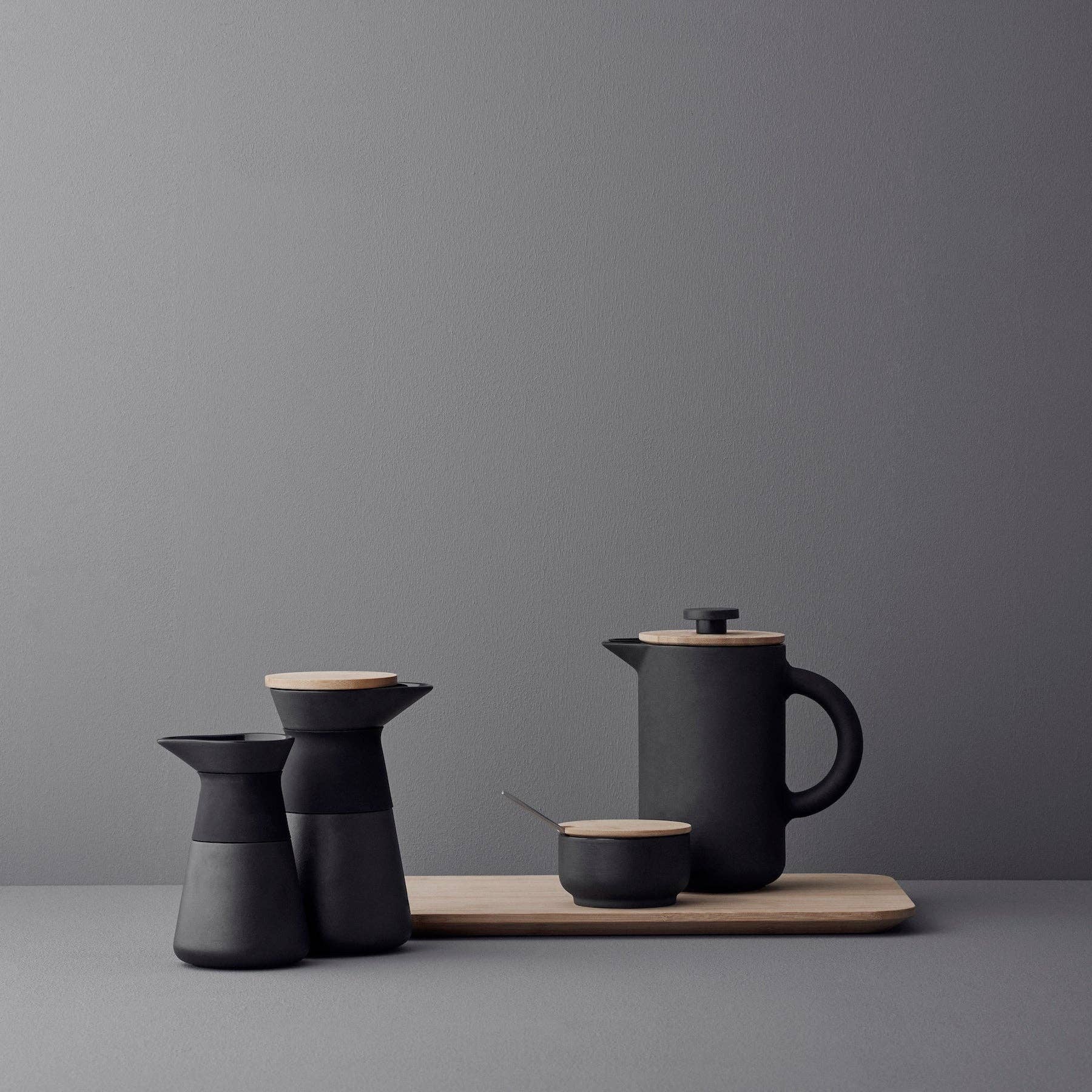 Stelton Theo Set in matte black stoneware with glossy interior, designed by Francis Cayouette. Rustic yet modern Nordic.