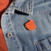 Shell Pin Badge by Kautzi Illustrations in bright orange, made from sustainable maple wood