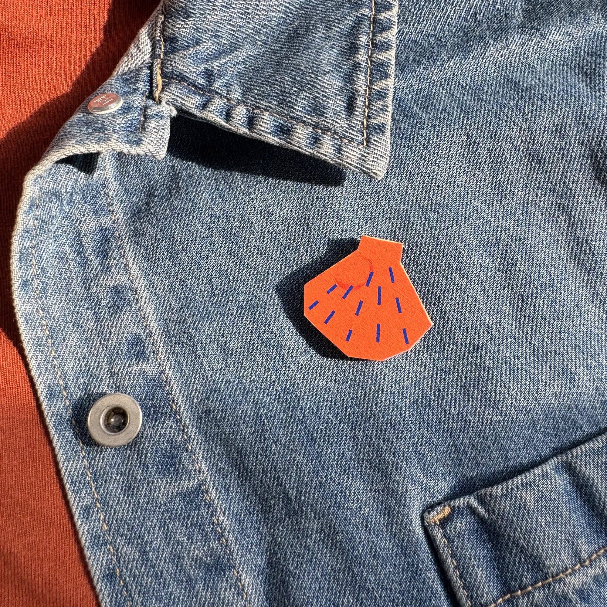 Shell Pin Badge by Kautzi Illustrations in bright orange, made from sustainable maple wood