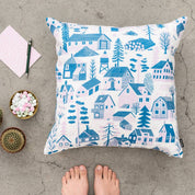 Mökkilä Cushion Cover featuring a playful Nordic village pattern by Bjørn Rune Lie in linen-cotton fabric with hidden zipper closure.