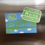 Little Something Co. Maine Vacationland Magnet featuring the green and white Maine State Line Vacationland sign.