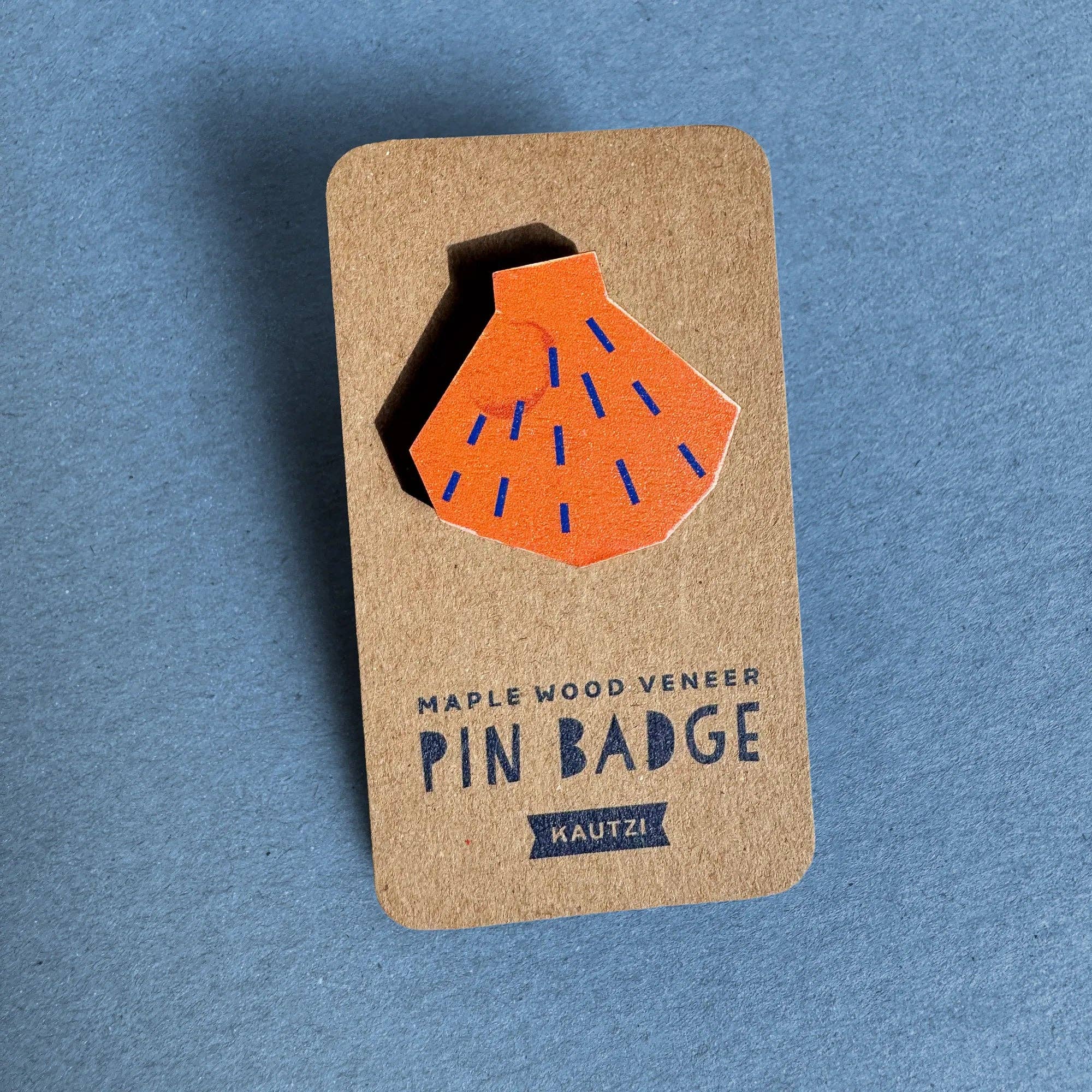 Shell Pin Badge by Kautzi Illustrations in bright orange, made from sustainable maple wood