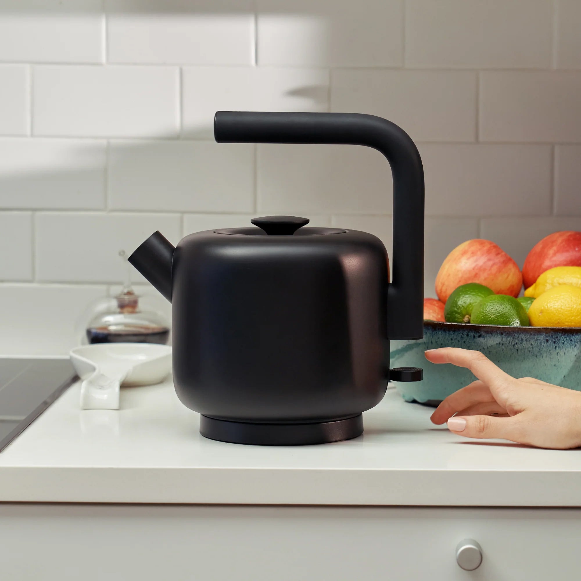 Fellow Clyde Electric Kettle in matte black stainless steel with wide mesh spout and silicone handle.