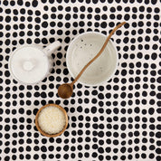 A World of Craft Dots Tablecloth, 140 × 260 cm, in white cotton with black dot print. Fair Trade, handmade in Bangladesh.