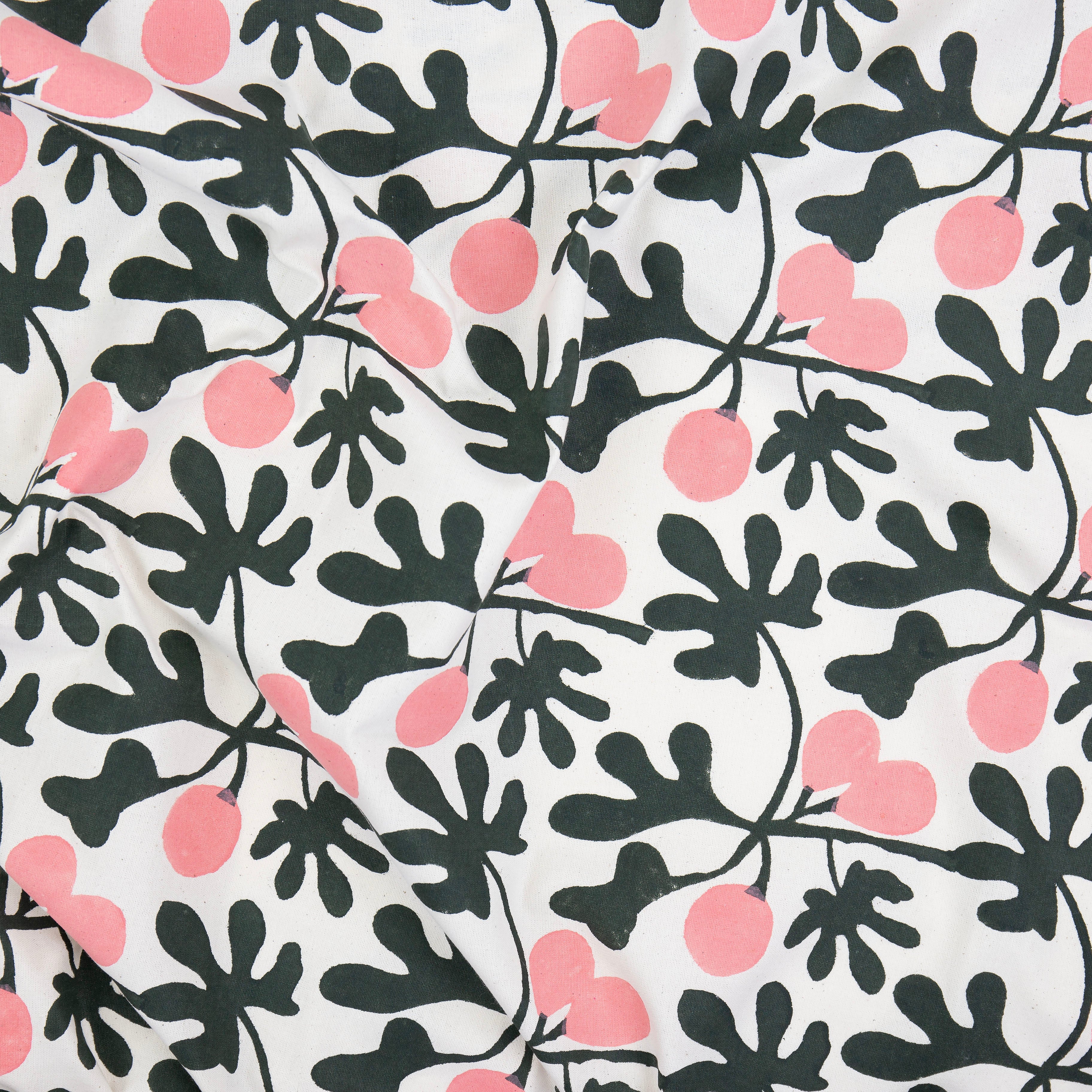 A World of Craft Fig Tablecloth, 140 × 260 cm, in green and pink botanical print. Hand block-printed cotton, Fair Trade from Bangladesh.