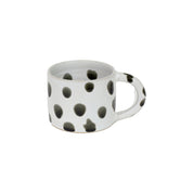 Blot Coffee Cup in matte light grey stoneware with glossy black dots. Handmade in Nepal, fair trade.