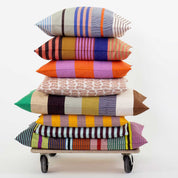 A World of Craft Olivia Cushion Cover with colorful mixed stripes in blue, pink, orange, green, red, and cream.