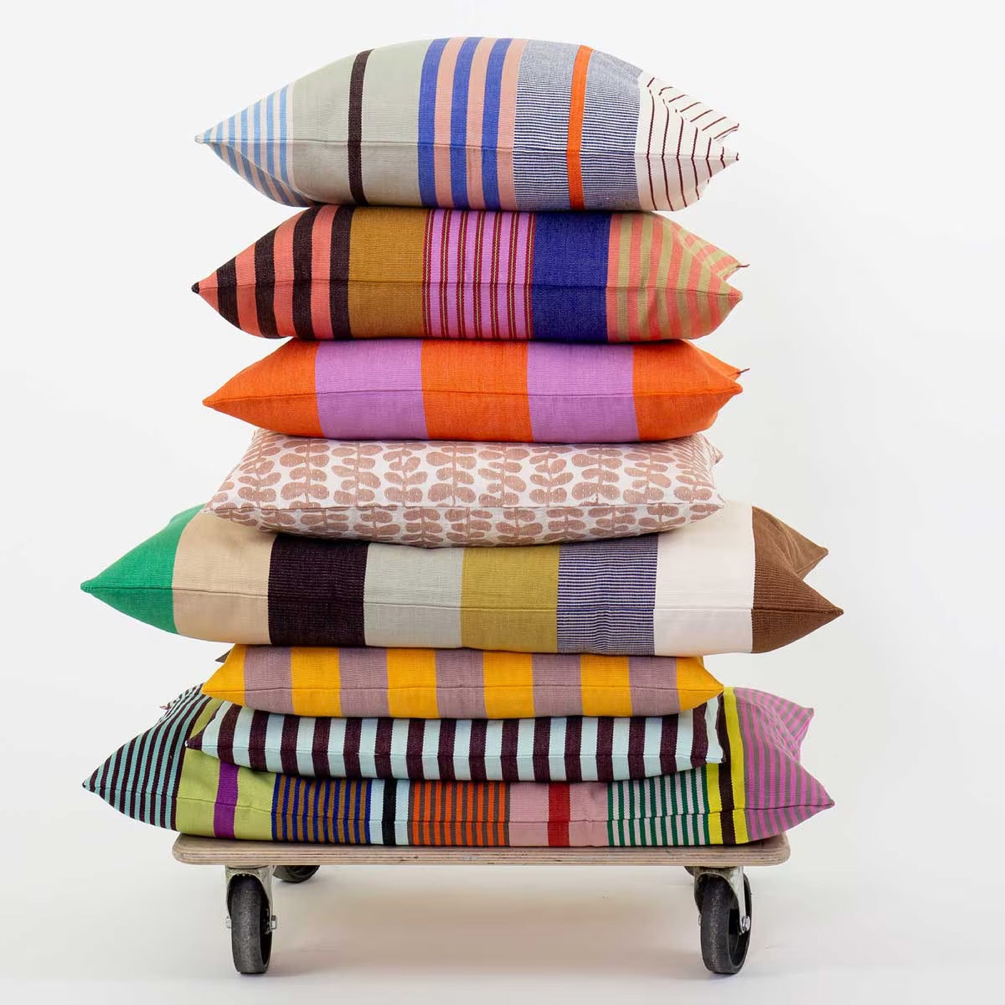 A World of Craft Olivia Cushion Cover with colorful mixed stripes in blue, pink, orange, green, red, and cream.