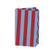 Nora Kitchen Towel by A World of Craft with wide blue and red handwoven cotton stripes, folded to show the bold striped pattern and textured reps weave.
