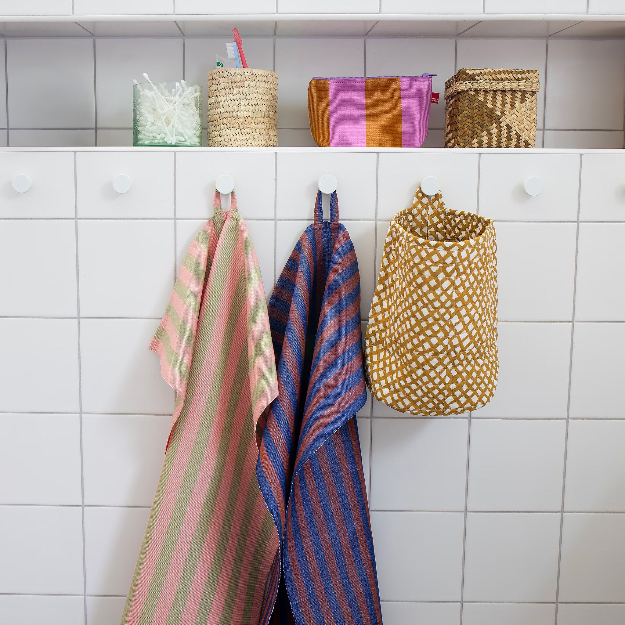 Zora Towel by A World of Craft in handwoven cotton with dark blue and brown vertical stripes.