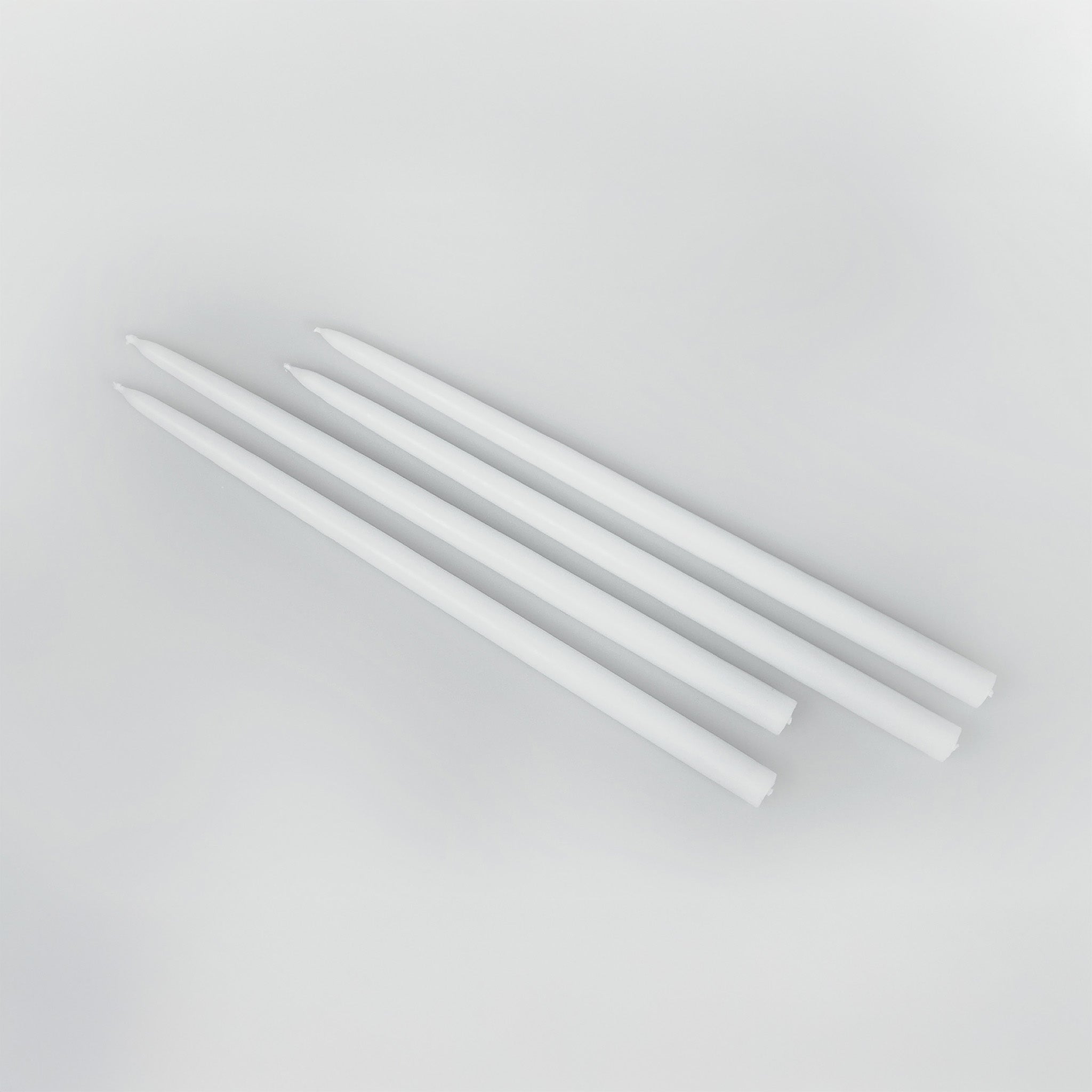 Architectmade white tapers for Gemini Candleholder by Peter Karpf in matte white stainless steel.