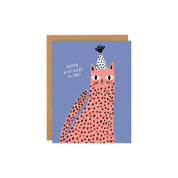 Spotted Cat Birthday Card by Badger & Burke featuring a pink spotted cat wearing a black-and-white party hat on a blue background.
