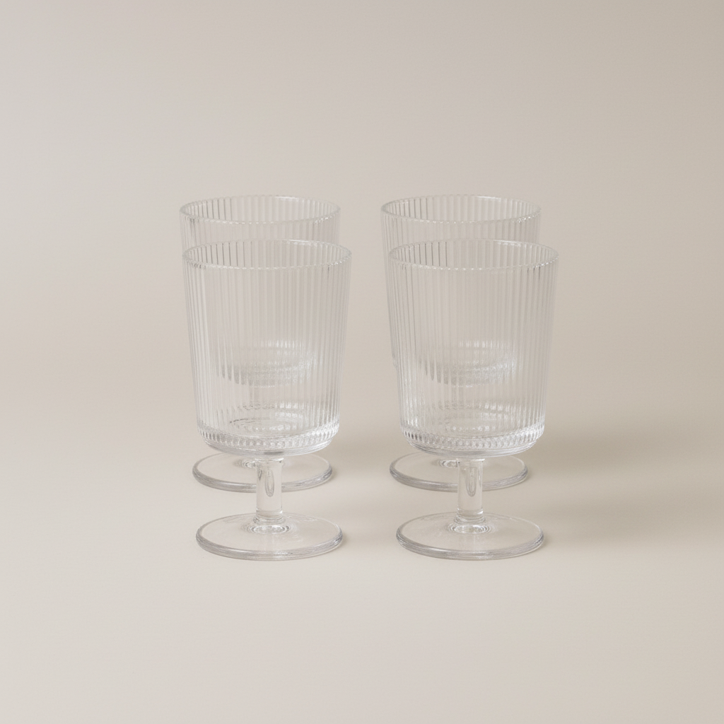 Pilastro Wine Glass Set by Stelton with four clear ribbed wine glasses featuring an Art Deco-inspired design and footed base.