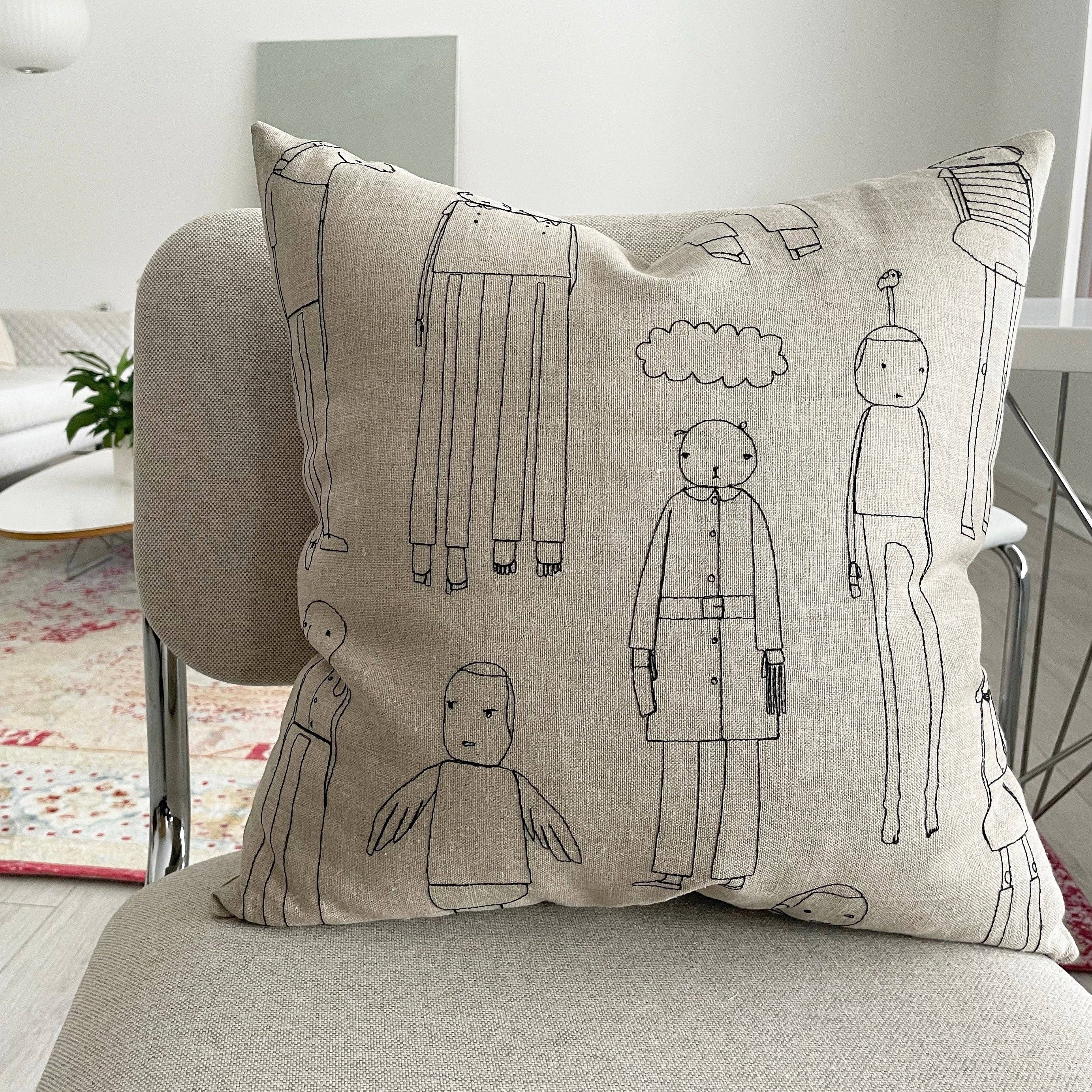 Everyday People Cushion by K Studio. Handcrafted in Grand Rapids, Michigan. Flax linen pillow with stitched character motif, zipper closure, and down-alternative insert—your new couch crew.