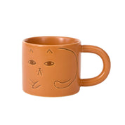 Donna Wilson Cat Mug in warm terracotta with debossed cat illustrations and chunky rounded handle.