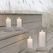 Stelton Hurricane Candle Holders in sand stoneware with glass shade, weather-resistant for indoor or outdoor candlelight.