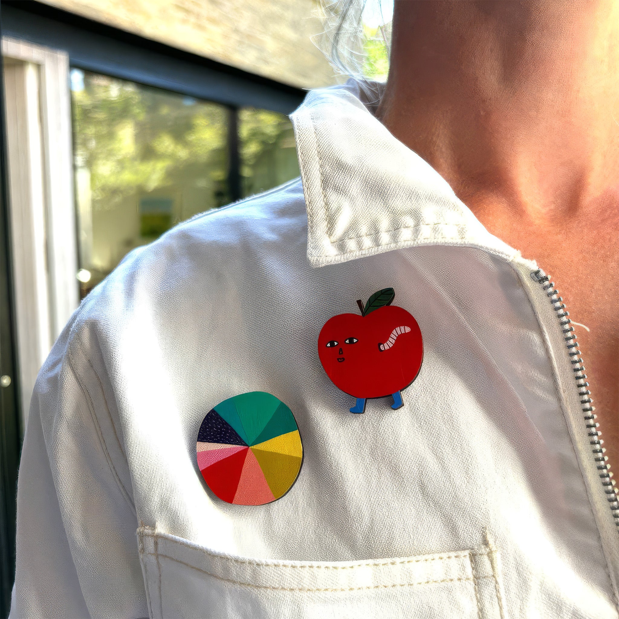 Donna Wilson Colour Wheel Pin Badge made from sustainably sourced beech wood, featuring a colorful painted wheel design with a metal butterfly clutch backing.