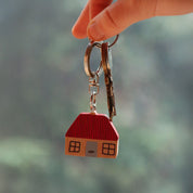 Donna Wilson House Keyring in FSC wood, house-shaped design with metal ring. Fun and durable key charm—pairs perfectly with the Leaf Keyring.