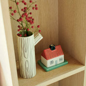 Donna Wilson Log Jug / Vase in cream stoneware with brown hand-drawn woodgrain stripes and sculptural twig handle.