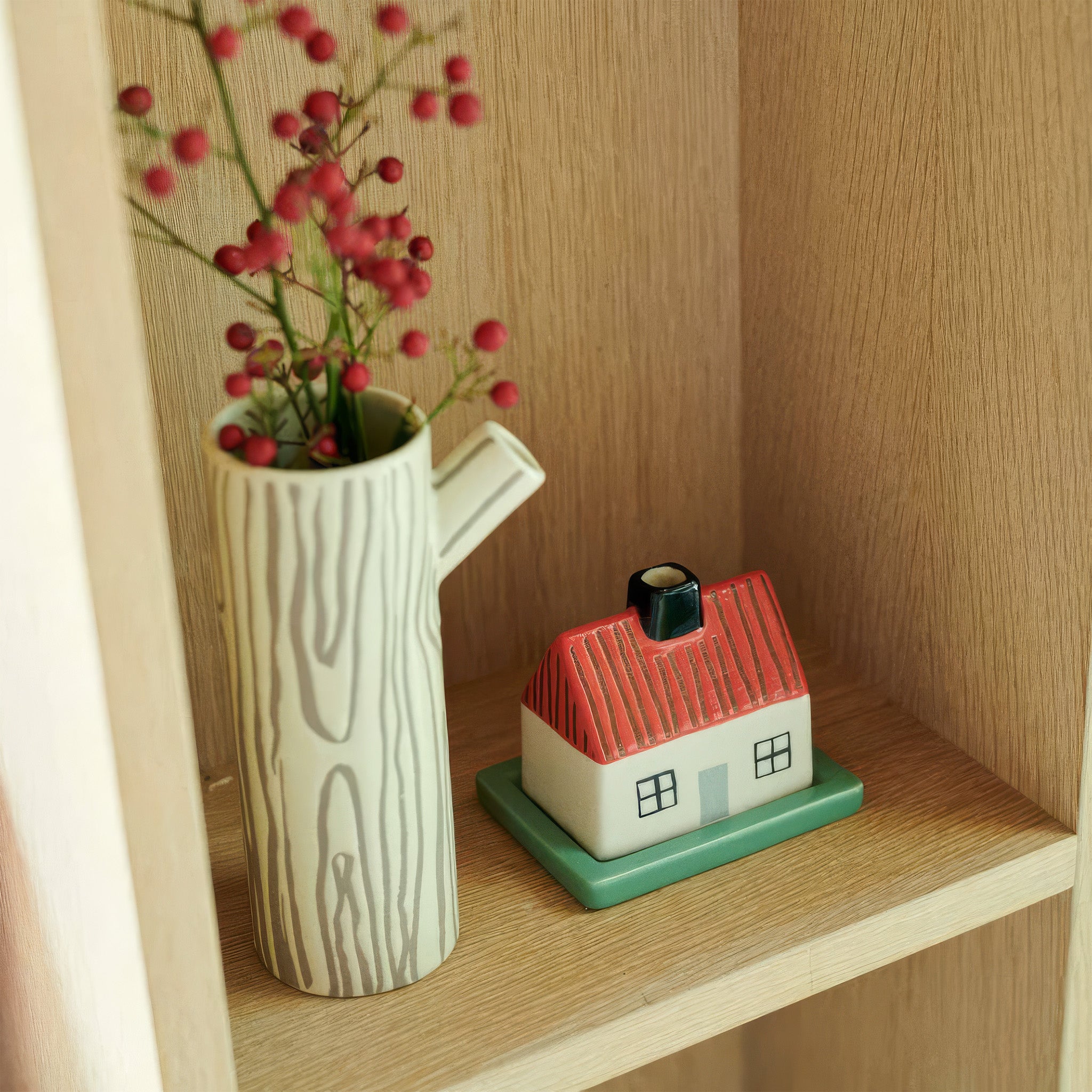  Vase in cream stoneware with brown hand-drawn woodgrain stripes and sculptural twig handle.