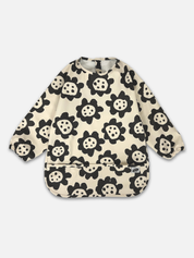 Long sleeve smock bib in six artist-designed colorways. Waterproof, recycled fabric, fits 6 months–3 years—extra coverage for mealtime and crafts.
