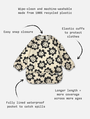 Long sleeve smock bib in six artist-designed colorways. Waterproof, recycled fabric, fits 6 months–3 years—extra coverage for mealtime and crafts.