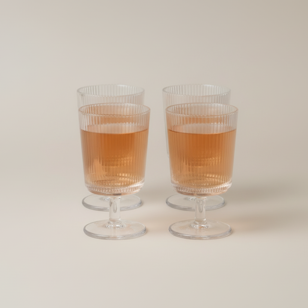 Pilastro Wine Glass Set by Stelton with four clear ribbed wine glasses featuring an Art Deco-inspired design and footed base.