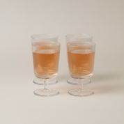 Pilastro Wine Glass Set by Stelton with four clear ribbed wine glasses featuring an Art Deco-inspired design and footed base.