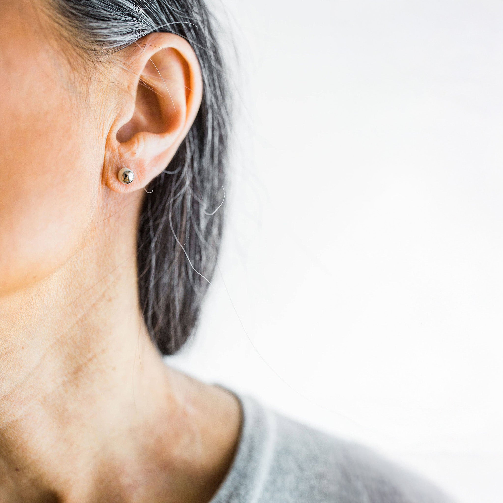 Silver porcelain dot stud earrings by Jenna Vanden Brink, handmade kiln-fired porcelain studs with titanium hardware