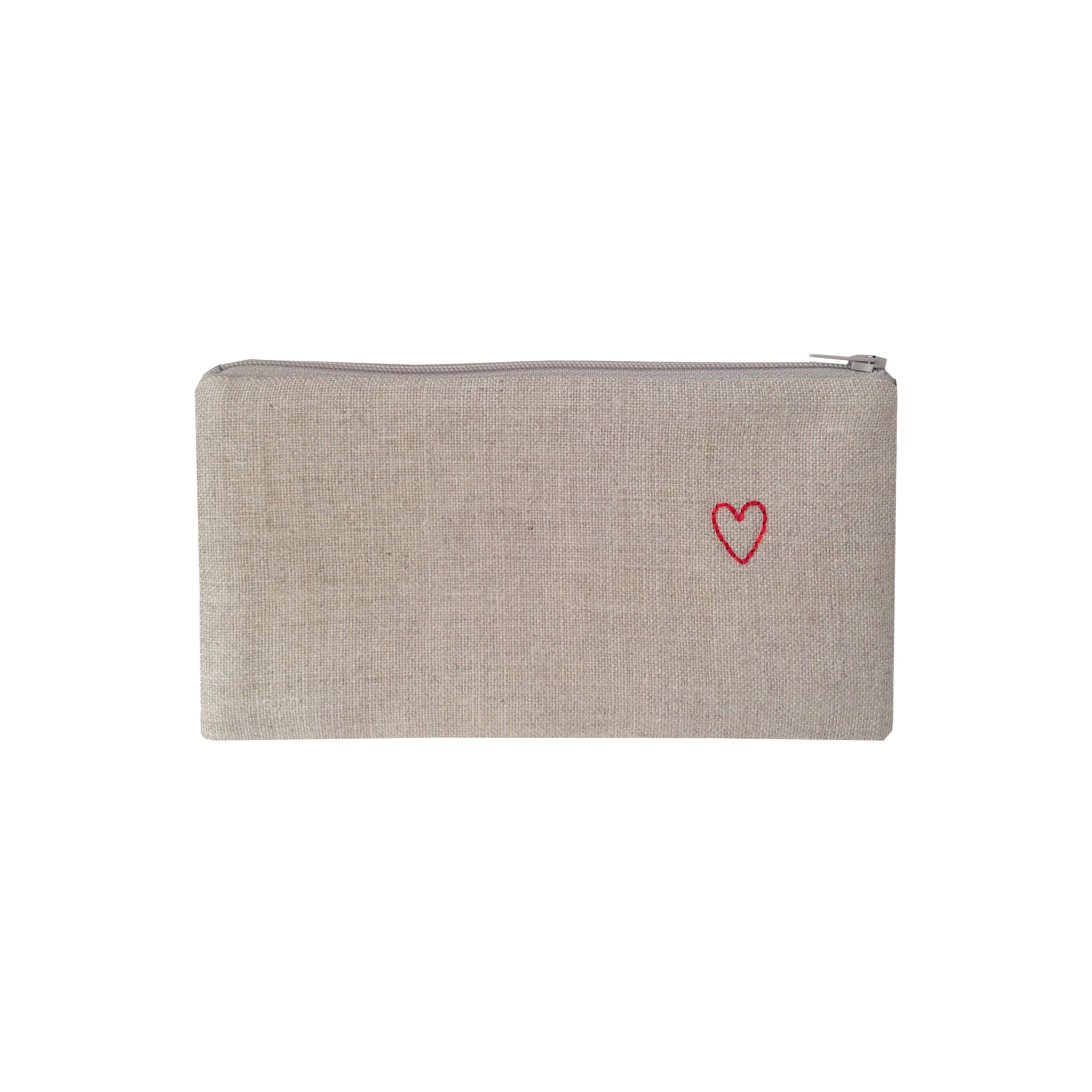 Tiny Heart Pouch by K Studio made of natural flax linen with a small red stitched heart, zip closure, and slim rectangular shape on a neutral background.