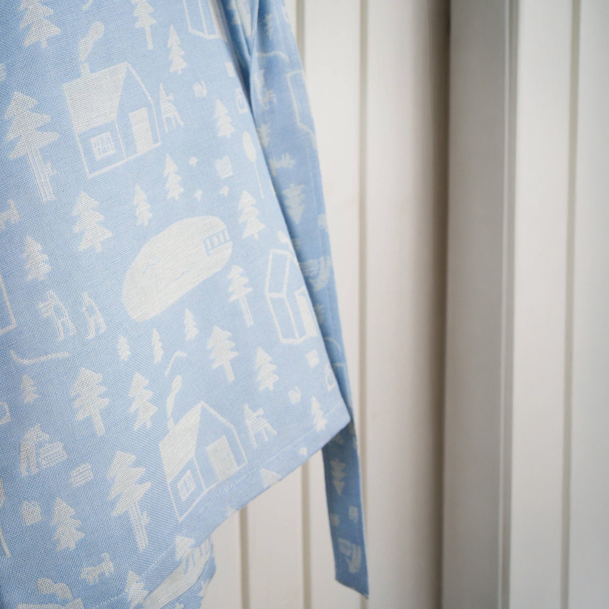 Sauna Robe by Kauniste in reversible cotton-linen jacquard with Riikka Laakso’s Finnish sauna, lake, and forest pattern.