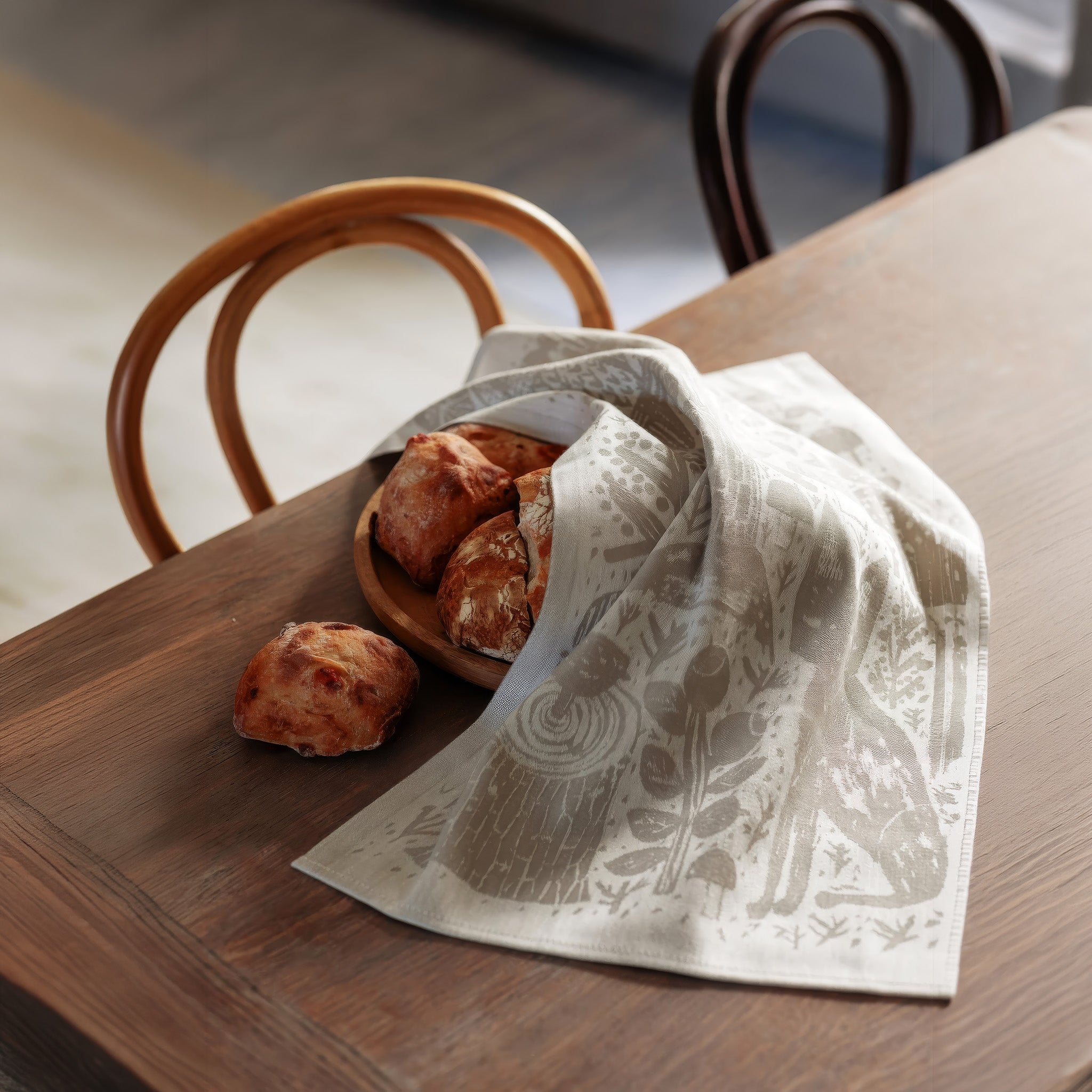 Lapuan Kankurit Metsikkö linen kitchen towel featuring a woodland illustration with a fox, owl, squirrel, mushrooms, and trees in natural linen and white.