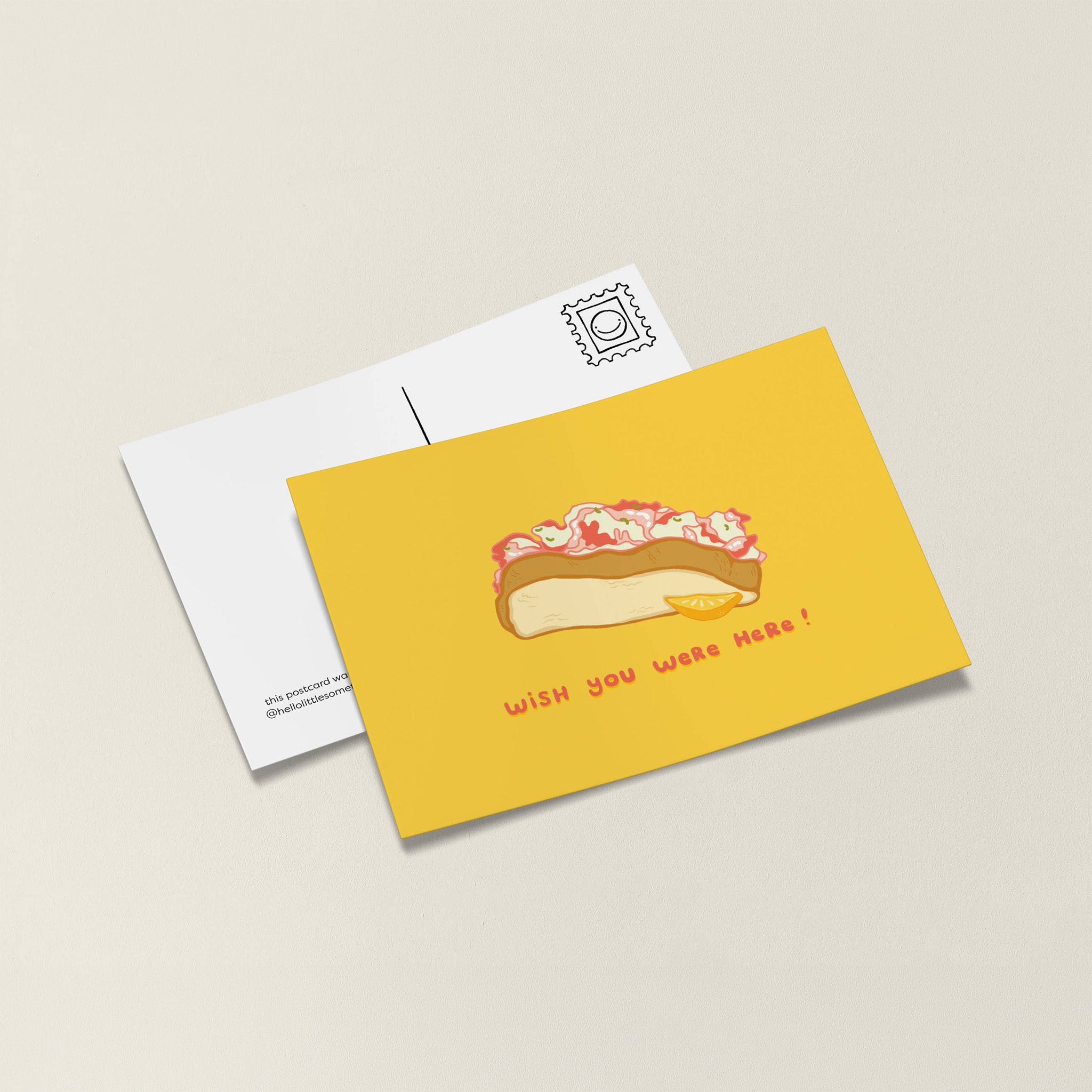 Little Something Co. Lobster Roll Postcard featuring an illustrated Maine lobster roll with lemon wedge and “Wish You Were Here!” on a yellow background.