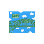 Vacationland Print by Little Something Co. featuring the green Piscataqua River Bridge, Maine Vacationland sign, white clouds, and bright blue sky.