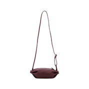 Marimekko Pikku Karla Shoulder Bag in smooth leather with a sculptural candy wrapper-inspired shape, adjustable shoulder strap, and zip closure.