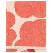 Unikko Hand Towel by Marimekko in bold floral pattern, 100% organic cotton terry towel in rectangular 50 × 70 cm size, soft and absorbent for bathroom or kitchen use.