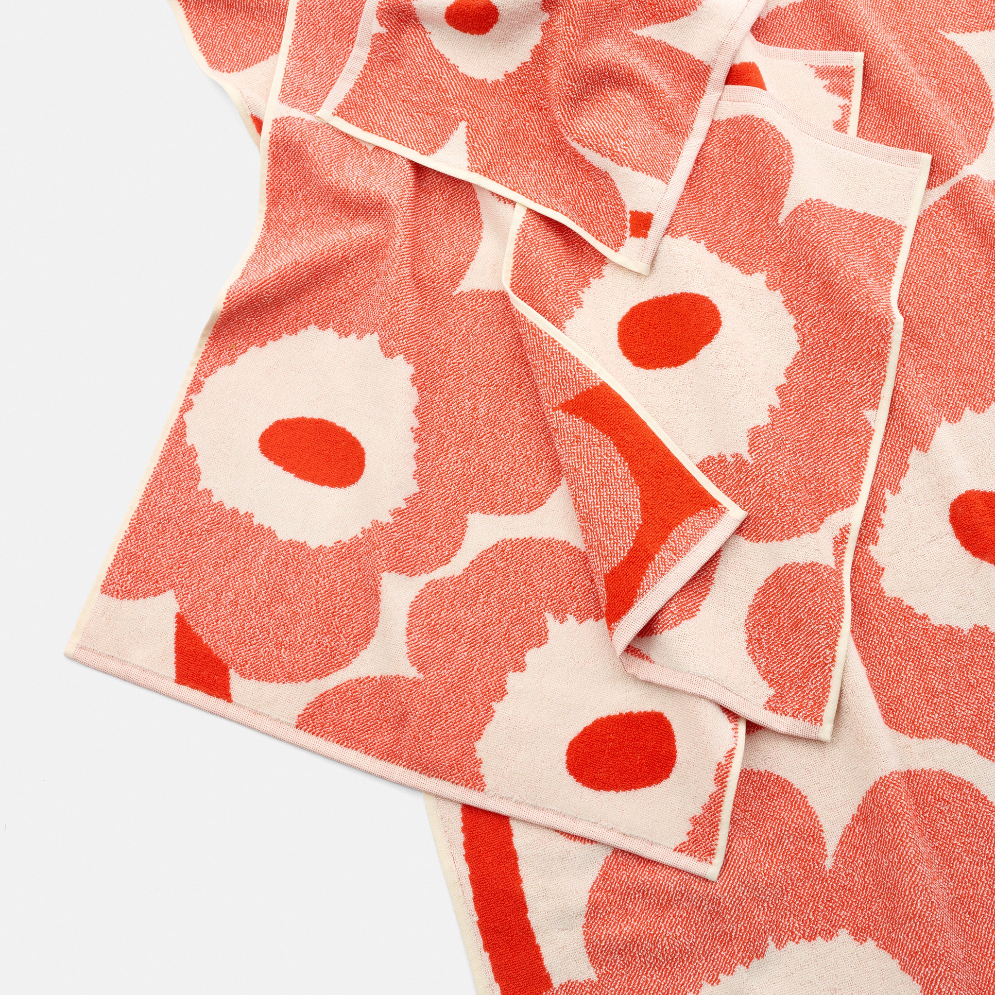 Unikko Hand Towel by Marimekko in bold floral pattern, 100% organic cotton terry towel in rectangular 50 × 70 cm size, soft and absorbent for bathroom or kitchen use.