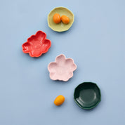 Marimekko Unikko and Kivet mini plate set with colorful flower and stone shaped ceramic plates in box.