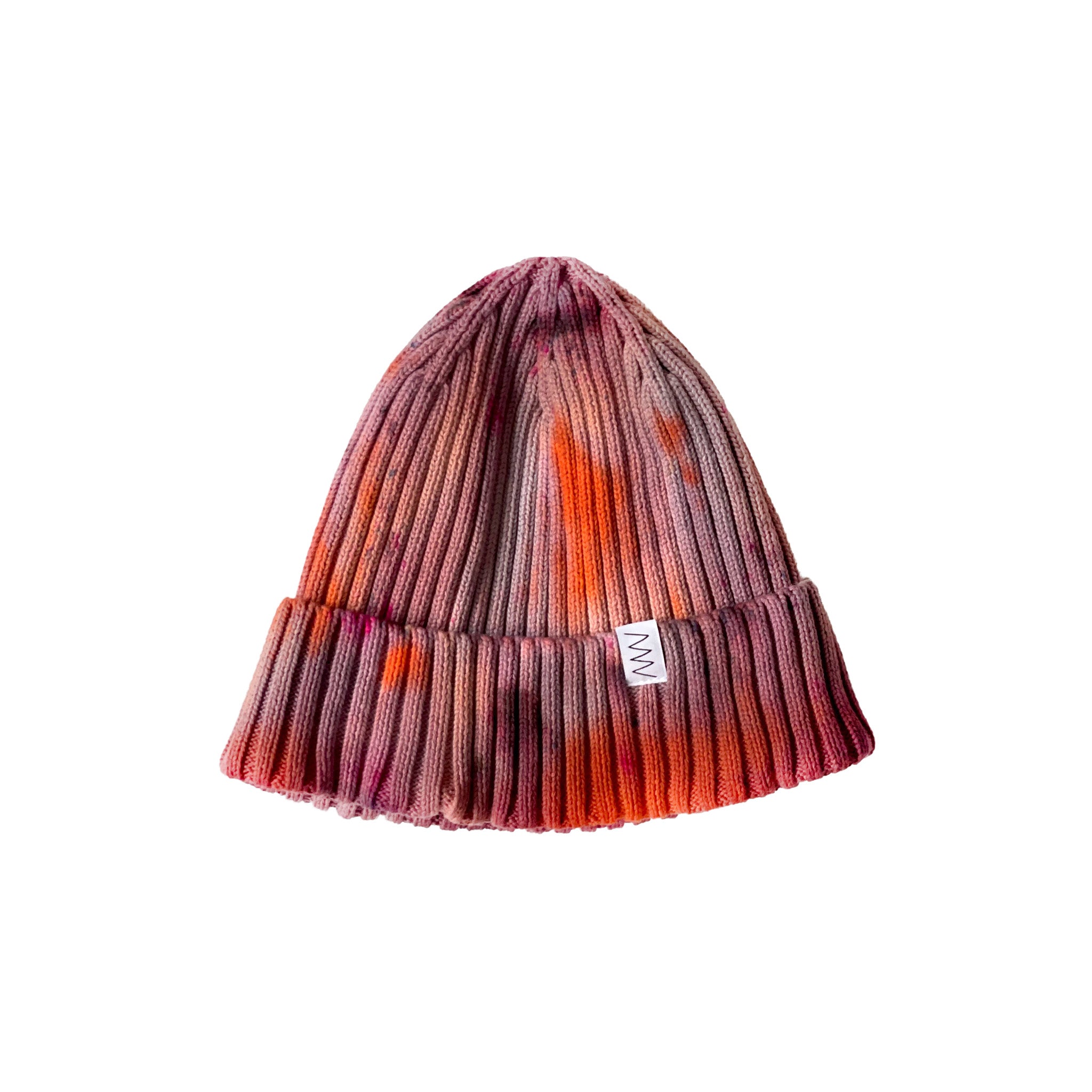 Brunette Hand-Dyed Beanie Hat by Merle Works featuring a ribbed cotton-blend knit in earthy shades of dusty rose, warm brown, rusty orange, and pink, with a folded cuff and woven logo tag.