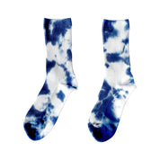 Indigo Tie-Dye Dressy Socks by Merle Works featuring white ribbed cotton with bold, irregular indigo blue hand-dyed patterns, arranged as an overlapping pair.