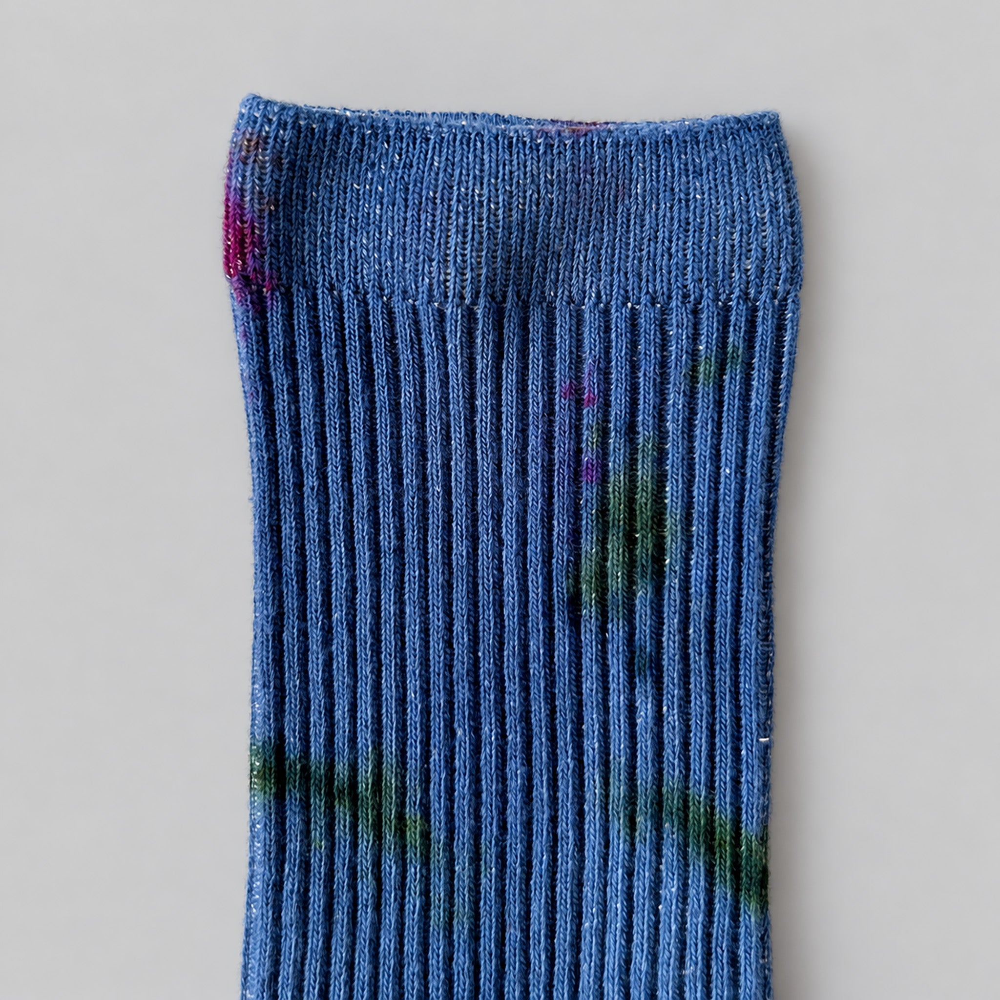 Painters Hand-Dyed Dressy Socks by Merle Works featuring blue ribbed cotton with scattered green, purple, and pink paint-like speckles inspired by a French painter's workwear.