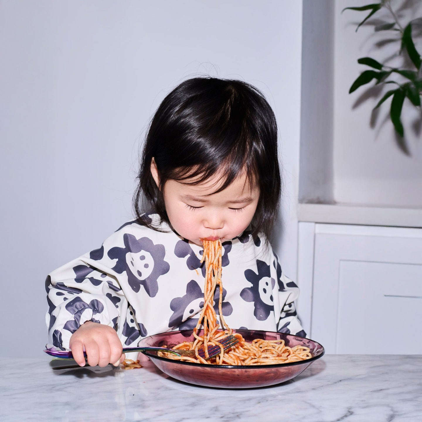 Long sleeve smock bib in six artist-designed colorways. Waterproof, recycled fabric, fits 6 months–3 years—extra coverage for mealtime and crafts.