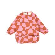 Long sleeve smock bib in six artist-designed colorways. Waterproof, recycled fabric, fits 6 months–3 years—extra coverage for mealtime and crafts.