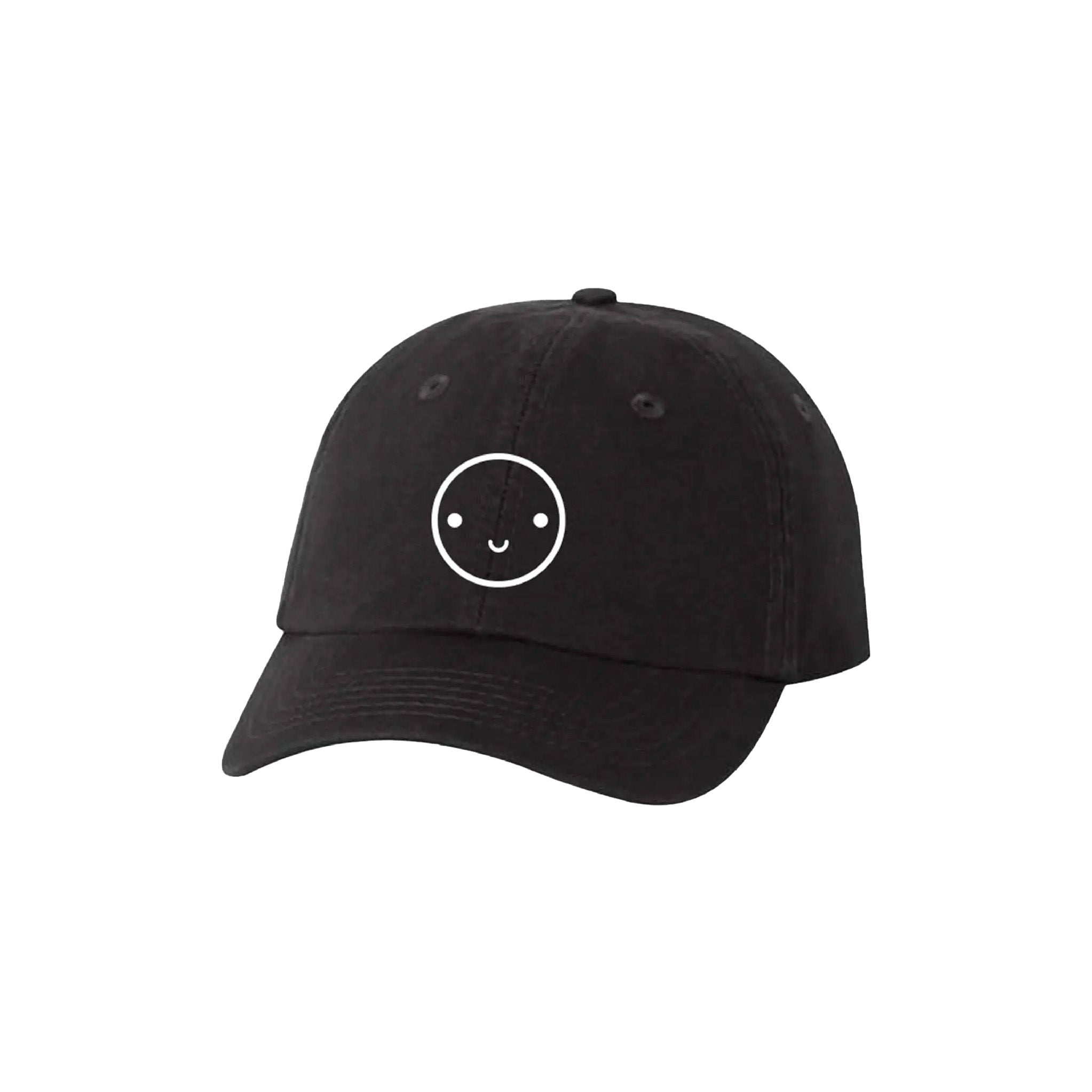 Mochi Kids Happy Dad Hat in Black / White with embroidered smiley face, curved brim, and adjustable fabric strap with brass slider closure.